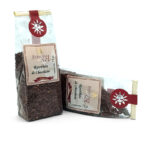 Two translucent tea sachets labeled 'Rooibos de Chocolate' with a red sun logo on a white background—Especias del SOL packaging.