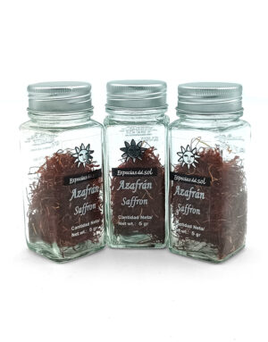 Three glass spice jars with metal lids, filled with saffron threads and labeled Azafrán Saffron (net wt. 5 g each).