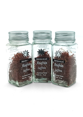 Three glass jars with silver lids containing saffron threads; labels read 'Azafrán Saffron'.