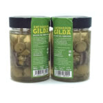 1777484622796 - El Gourmext de Casa Chino Two glass jars of anchovy-stuffed green olives labeled 'GILDA' with black lids, standing side by side on a white background.