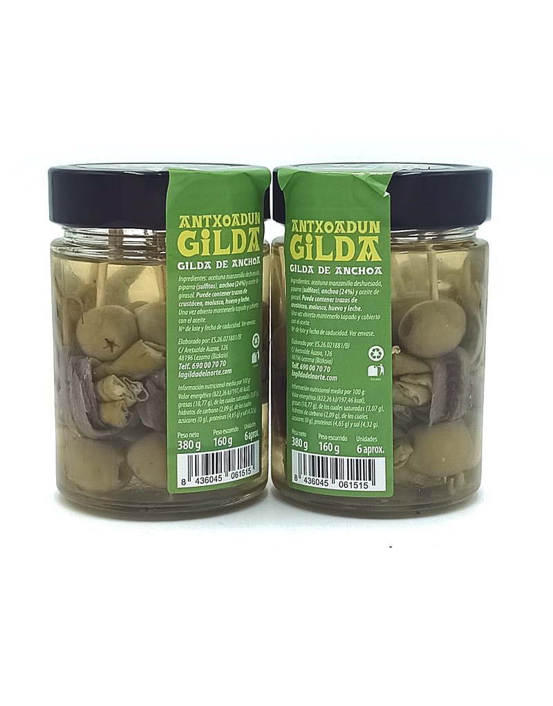 1777484622796 - El Gourmext de Casa Chino Two glass jars of anchovy-stuffed green olives labeled 'GILDA' with black lids, standing side by side on a white background.