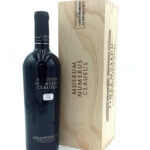 1777484623367b - El Gourmext de Casa Chino Dark wine bottle labeled Museum Numerus Clausus beside a matching wooden crate with the same text.