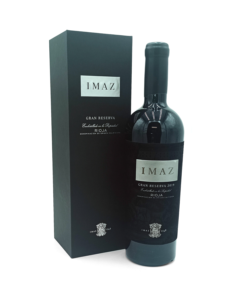 1777484623768b - El Gourmext de Casa Chino Bottle of IMAZ Gran Reserva 2019 Rioja wine beside its black presentation box, label reading IMAZ and Gran Reserva 2019.