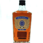 Bottle of Granadilla Ron Añejo aged rum with an ornate gold label and amber liquid, centered on a white background.