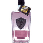 Pink gin bottle with a black cap and a gold award tag hanging from the neck; label shows Vetton Distilling Co.