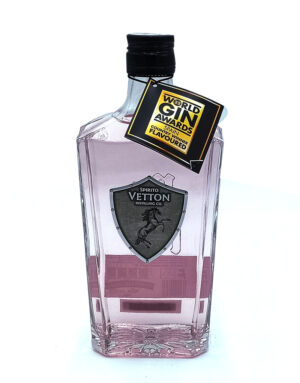 Pink-tinted gin bottle with black cap and an award tag reading World Gin Awards attached to the neck on the bottle outside.