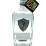 Clear gin bottle with a Vetton Distilling Co shield logo on the front and a World Gin Awards tag attached to the neck