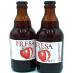 Two brown glass bottles of FRESA strawberry beverage with a white label showing a red strawberry illustration.