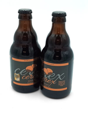 Two brown beer bottles with orange and black labels stand side by side on a white background, likely a paired craft beer set.