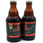 1777484624849 - El Gourmext de Casa Chino Two brown beer bottles with red and black labels and a cherry graphic, standing side by side on a white background.