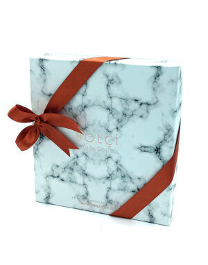 Marble-patterned light blue gift box with a red ribbon bow, labeled Bolci chocolate.