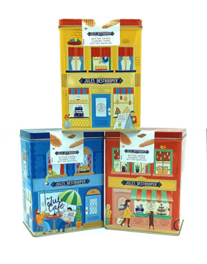 Three vintage-style tin boxes shaped like storefronts in yellow, blue, and red with Jules Destrooper branding.