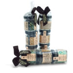 Three bundles of essential oil bottles with beige labels, wrapped in clear plastic and tied with black ribbons on a white background.