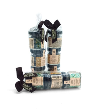 Three bundles of essential oil bottles with beige labels, wrapped in clear plastic and tied with black ribbons on a white background.
