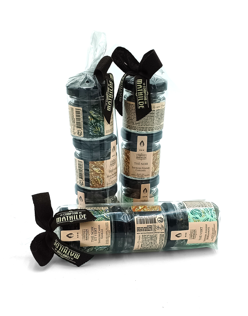 1777484625061 - El Gourmext de Casa Chino Gift set of small dark glass bottles wrapped in clear plastic with black ribbons, beige labels visible on each bottle.