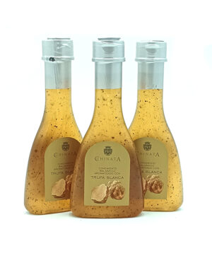 Three bottles of white truffle sauce with beige labels and silver caps.