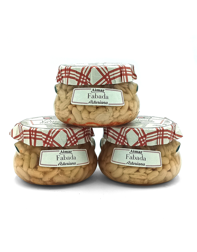 1777484625461 - El Gourmext de Casa Chino Three glass jars of Fabada Asturiana beans sealed with red plaid lids, stacked in a pyramid, ready for sale.