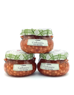 Three glass jars labeled Garbanzos con bacalao with green checkered lids on a white background.