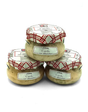 Three glass jars labeled Cardo con almendras stacked in a pyramid with red plaid lids on a white background