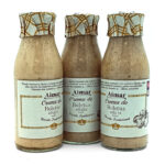 Three glass bottles of Aimar Crema de Boletus edulis mushroom cream sauce tied with patterned caps and beige labels labeled Receta Tradicional (traditional recipe).