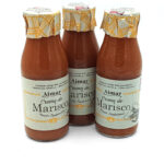 Three bottles of Aimar Crema de Marisco seafood cream sauce with patterned twist-off caps against a white background.