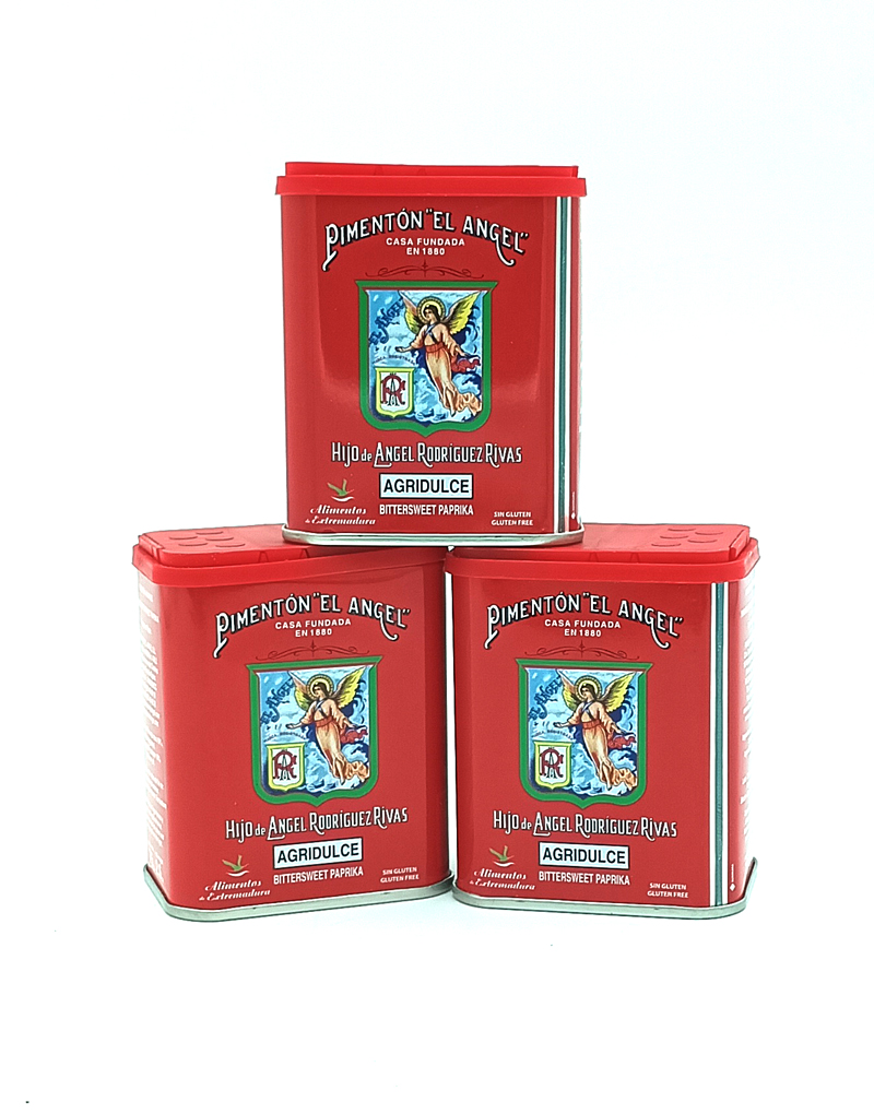 1778794820431 - El Gourmext de Casa Chino Three red metal tins of Pimentón 'El Ángel' stacked together, featuring an angel emblem and 'AGRIDULCE' on the front label.