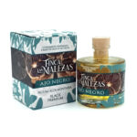 Bottle of Finca Las Malezas Ajo Negro olive oil with its matching box on a white background