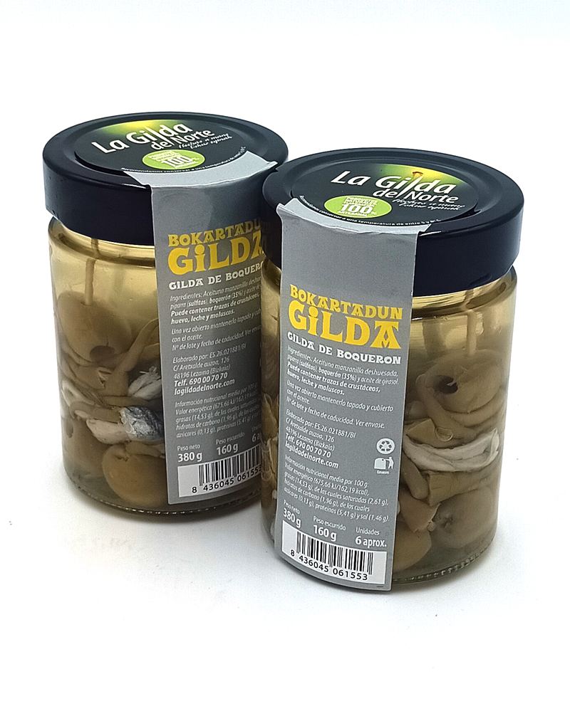 1777484622812 - El Gourmext de Casa Chino Two glass jars labeled La Gilda del Norte with pickled boquerón (anchovy) fillets in oil, sealed with dark lids and gray tags on a white background.