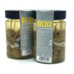 1777484622831 - El Gourmext de Casa Chino Two glass jars with black lids labeled Gilda de boquerón, containing marinated anchovy skewers in oil.