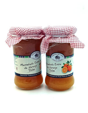 Two glass jars of orange marmalade with red checkered cloth lids tied with string.