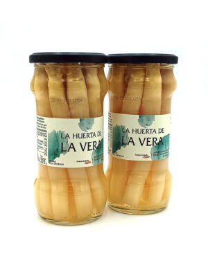 1778794818791 - El Gourmext de Casa Chino Two glass jars with black lids labeled La Huerta de La Vera, filled with light brown pickled peppers side by side on a white background, front labels visible.