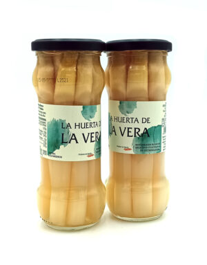 1778794819009 - El Gourmext de Casa Chino Two glass jars of white asparagus standing side by side with dark lids and light teal labels reading 'La Huerta de La Vera' on a white background.