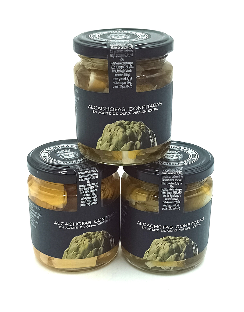 1778794819181 - El Gourmext de Casa Chino Three glass jars of artichokes confit in extra virgin olive oil, stacked in a pyramid against a white background, with dark labels.