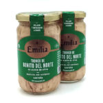 1778794819509 - El Gourmext de Casa Chino Two glass jars of Emilia bonito del Norte tuna in olive oil with green labels and gold lids on a white background.