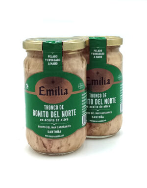 1778794819509 - El Gourmext de Casa Chino Two glass jars of Emilia bonito del Norte tuna in olive oil with green labels and gold lids on a white background.