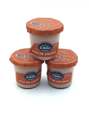 1778794819796 - El Gourmext de Casa Chino Three glass jars of Conservas Emilia Paté de Anchoa with orange foil lids, stacked in a triangular formation with red labels.