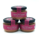 1778794819929 - El Gourmext de Casa Chino Three jars of Iberico pork pâté with cherry in extra virgin olive oil, pink label and black lids on a white surface.