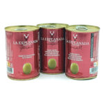 1778794820080 - El Gourmext de Casa Chino Three red cans of La Explanada Gourmet green olives arranged in a row, olive product label visible on each can