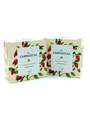 1778794820307 - El Gourmext de Casa Chino Two cream boxes with red chili pepper illustrations and a white label that reads 'El CARRASCAL'—artisanal piquillo peppers (Artesanos).