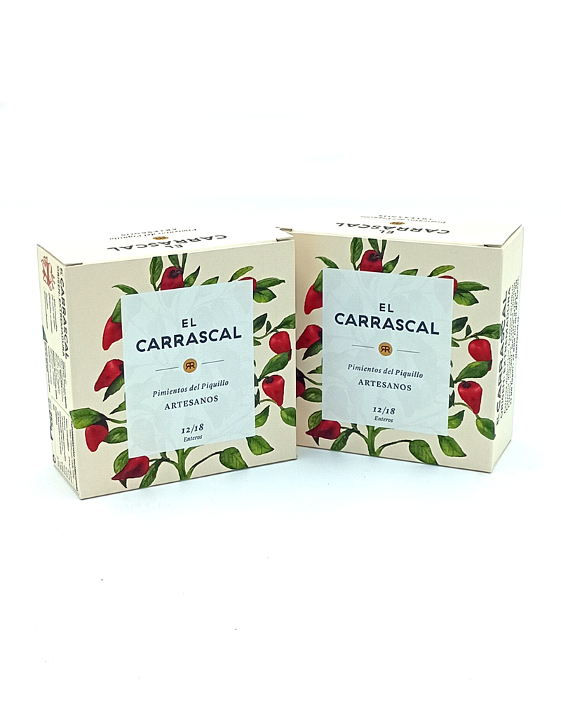 1778794820317 - El Gourmext de Casa Chino Two beige boxes with red chili illustrations and a blue label that reads 'EL CARRASCAL Pimientos del Piquillo ARTESANOS'.