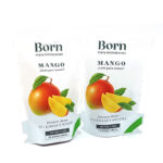 Two white stand-up pouches labeled 'Born' and 'Mango' containing dried mango, with a large mango illustration on the front.