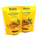 1778794820826 - El Gourmext de Casa Chino Two yellow stand-up pouches labeled Born Fruta Deshidratada with 'Jengibre' ginger candy, showing ginger pieces on the front.
